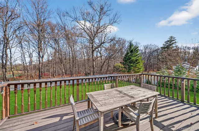 a view of a wooden deck and a yard
