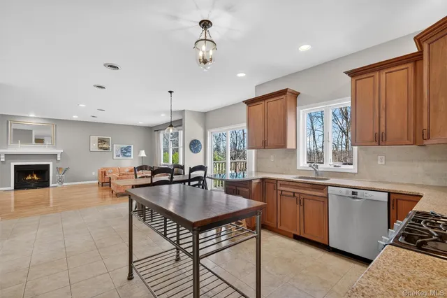 a kitchen with sink refrigerator dining table and chairs