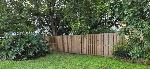 a kitchen with granite countertop a refrigerator and a stove top oven