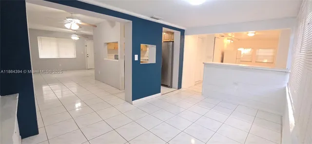 a view of a kitchen with a refrigerator and window