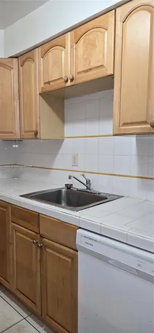 a utility room with cabinets washer and dryer