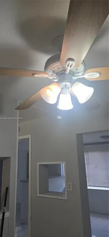 a view of a livingroom with white tiles