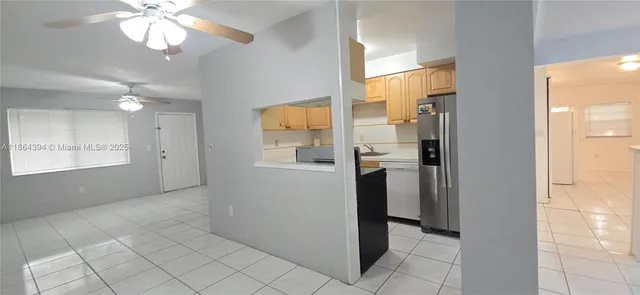 a view of a hallway with windows and chandelier