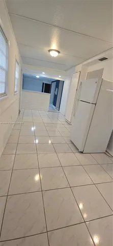 a view of an empty room with windows