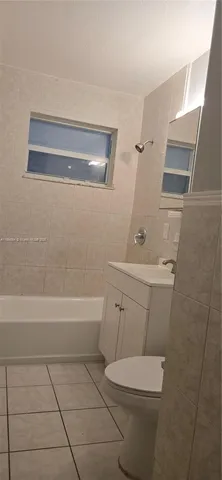 a bathroom with a bathtub and a sink