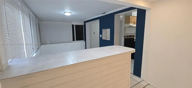 a kitchen with refrigerator and cabinets