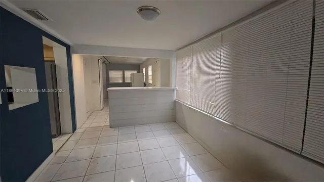 a view of empty room with window and fireplace