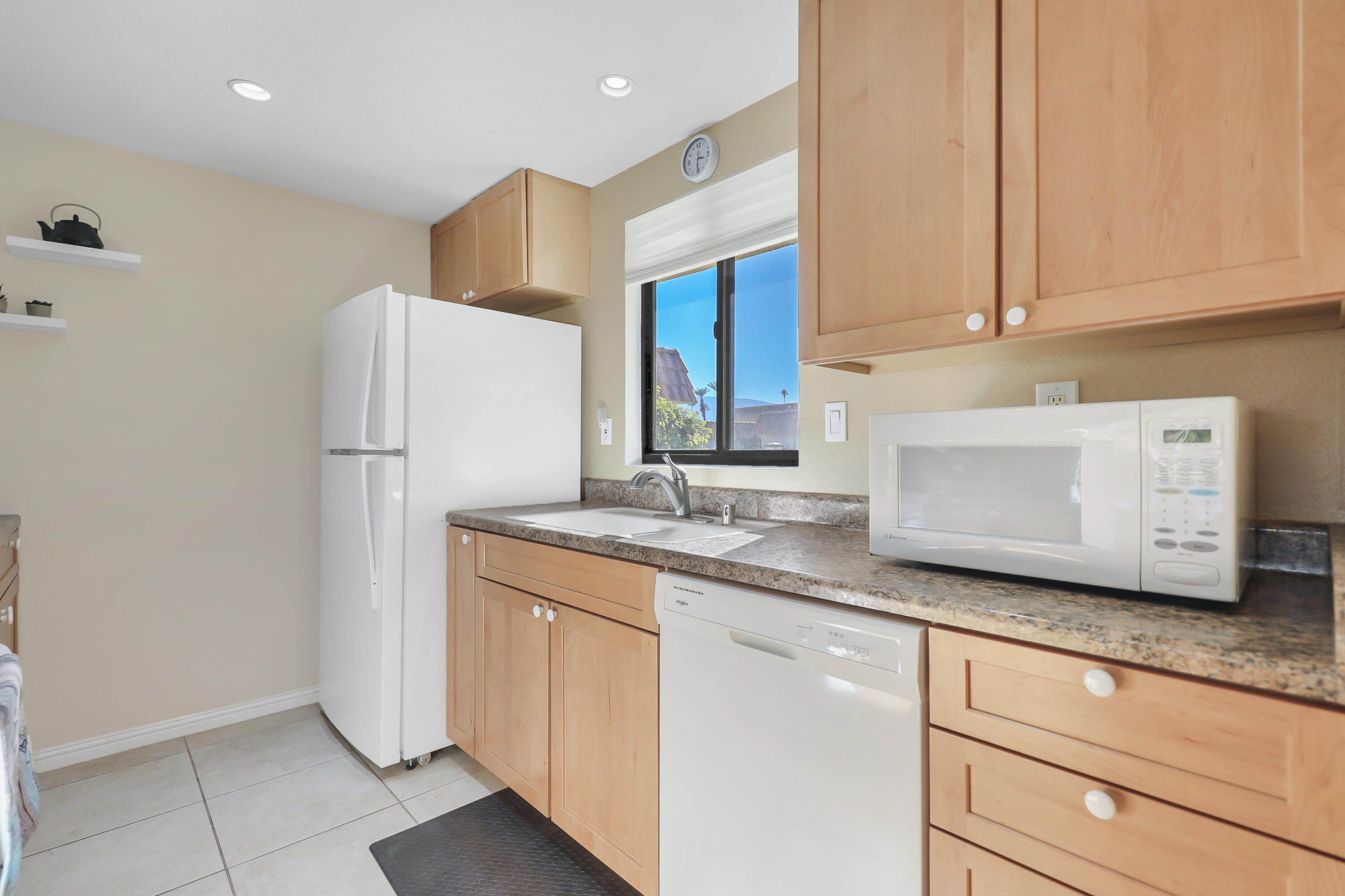 41476 Inverness Way Palm Desert, CA 92211 - Photo 13 of 37 a kitchen with stainless steel appliances granite countertop a sink and a refrigerator