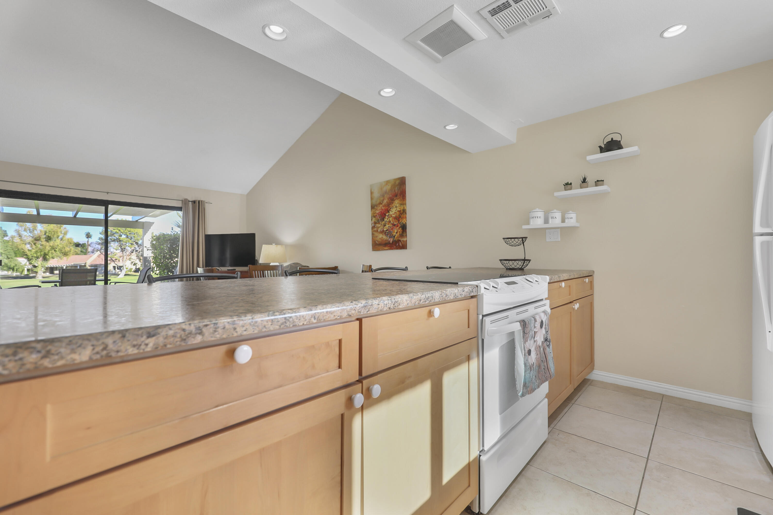 41476 Inverness Way Palm Desert, CA 92211 - Photo 14 of 37 a kitchen with stainless steel appliances granite countertop a sink and a stove