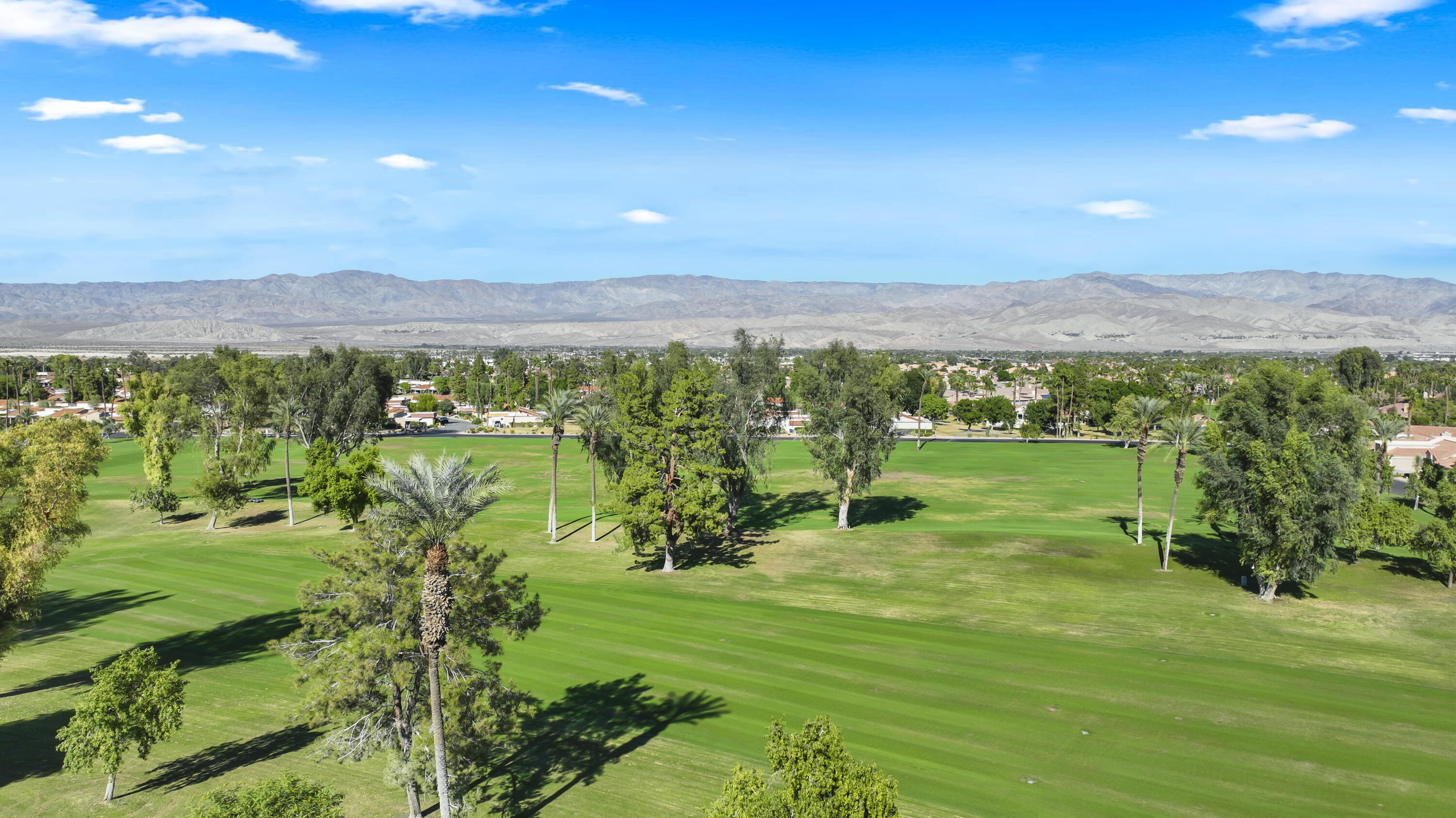 41476 Inverness Way Palm Desert, CA 92211 - Photo 21 of 37 a view of a city with lush green forest