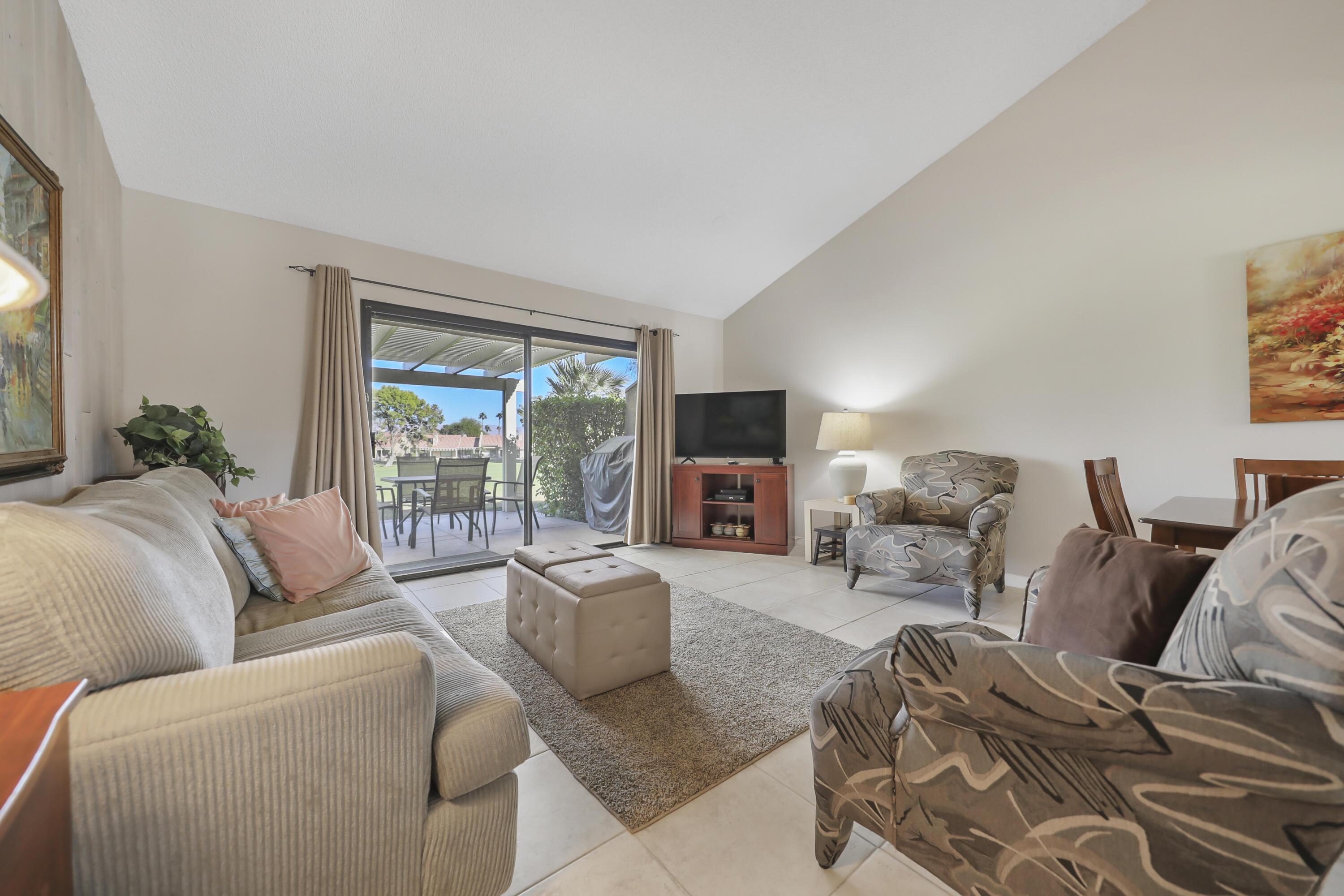41476 Inverness Way Palm Desert, CA 92211 - Photo 9 of 37 a living room with furniture large window and a flat screen tv