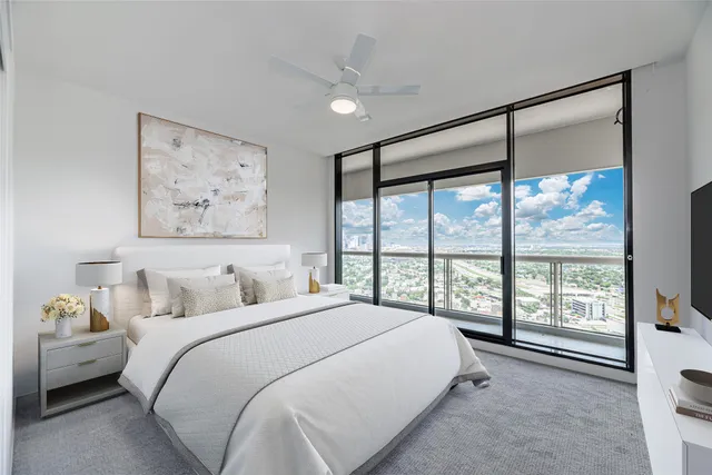 a bedroom with a large bed and a large window