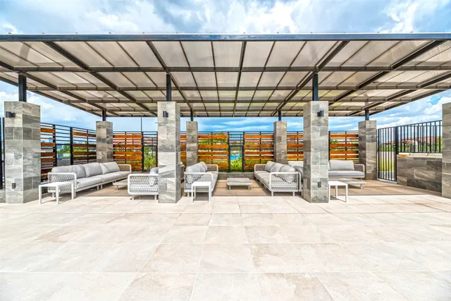 a building with glass top table and chairs