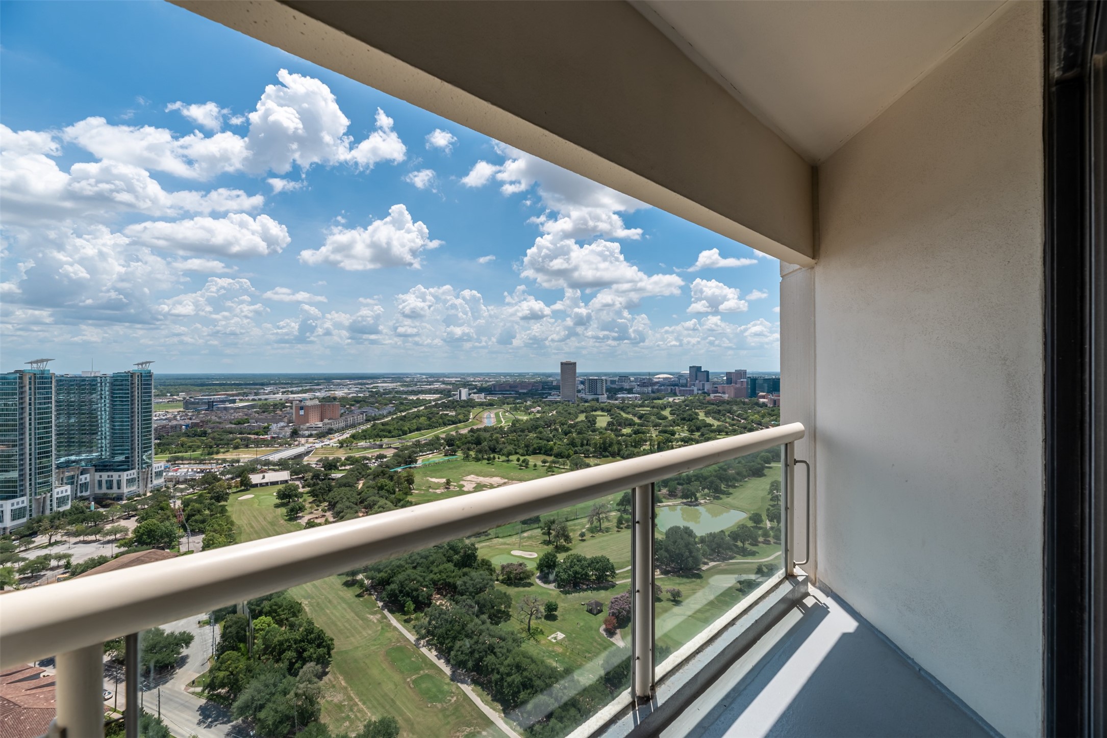 1701 Hermann Drive, Unit 34L Houston, TX 77004 - Photo 6 of 37 Glass balcony railings allow for unencumbered views.