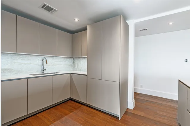 a kitchen with a sink and cabinets