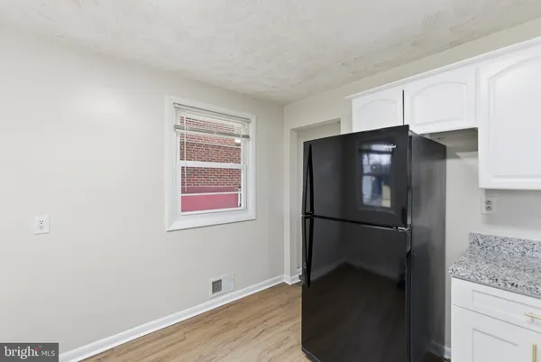 a kitchen with a refrigerator and cabinets