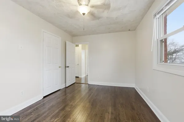 wooden floor in an empty room with a window