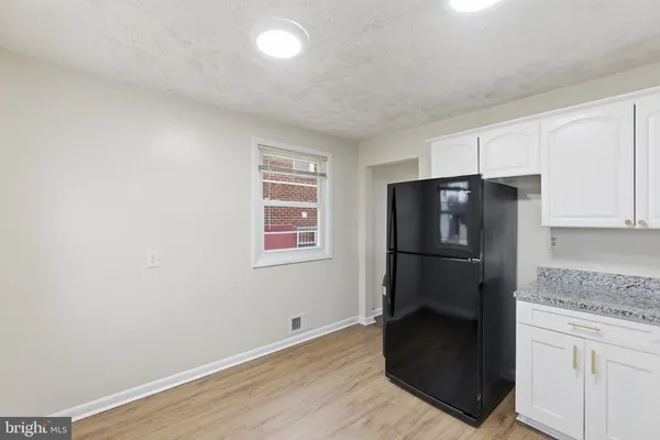 a kitchen with a refrigerator and window