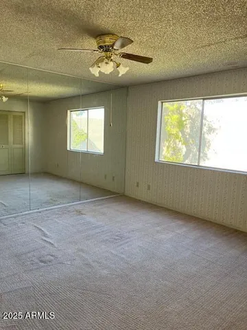 a view of a hallway with wooden floor and stairs