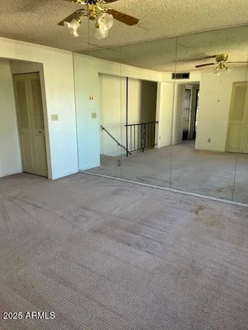 a view of a street with couches and palm trees