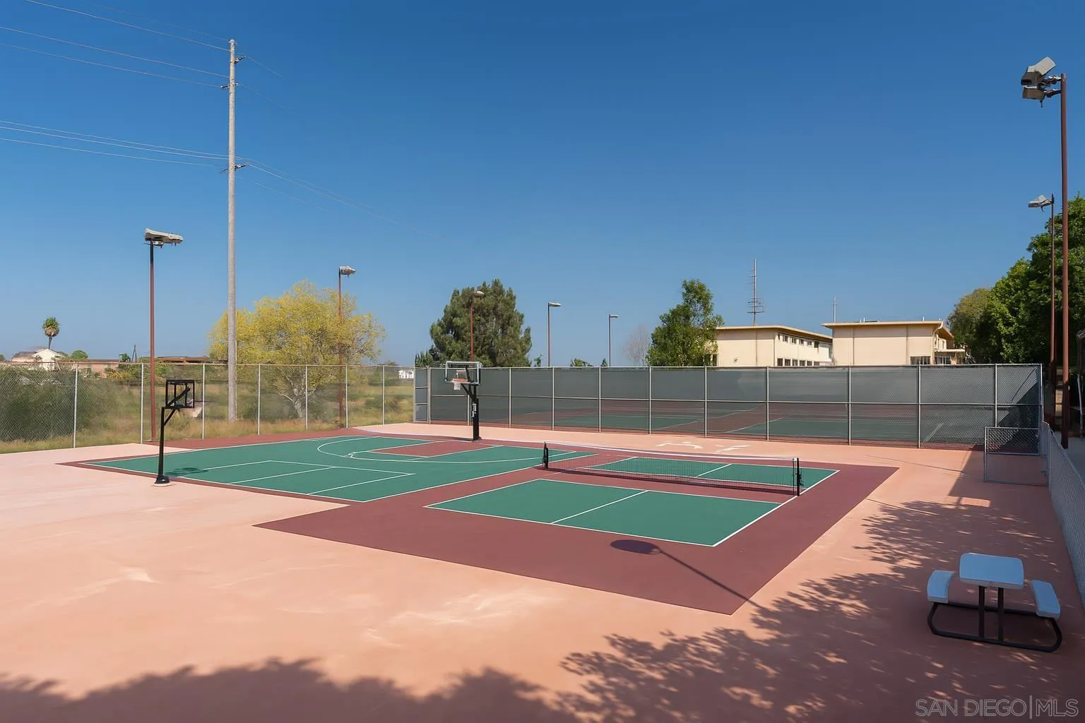 4032 Valeta Street, Unit 319 San Diego, CA 92110 - Photo 16 of 17 a swimming pool with some trees in the background