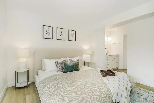 a bedroom with a bed and wooden floor