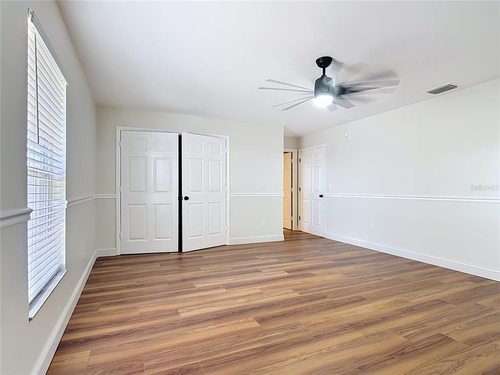 7925 Lake Mabel Loop Road Lake Wales, FL 33898 - Photo 62 of 97 a view of an empty room with wooden floor and a window
