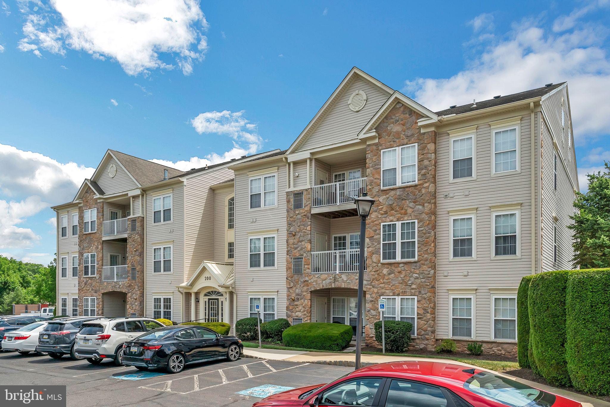 200 Beech Boulevard, Unit 104 Warrington, PA 18976 - Photo 1 of 30 a city street lined with buildings and cars