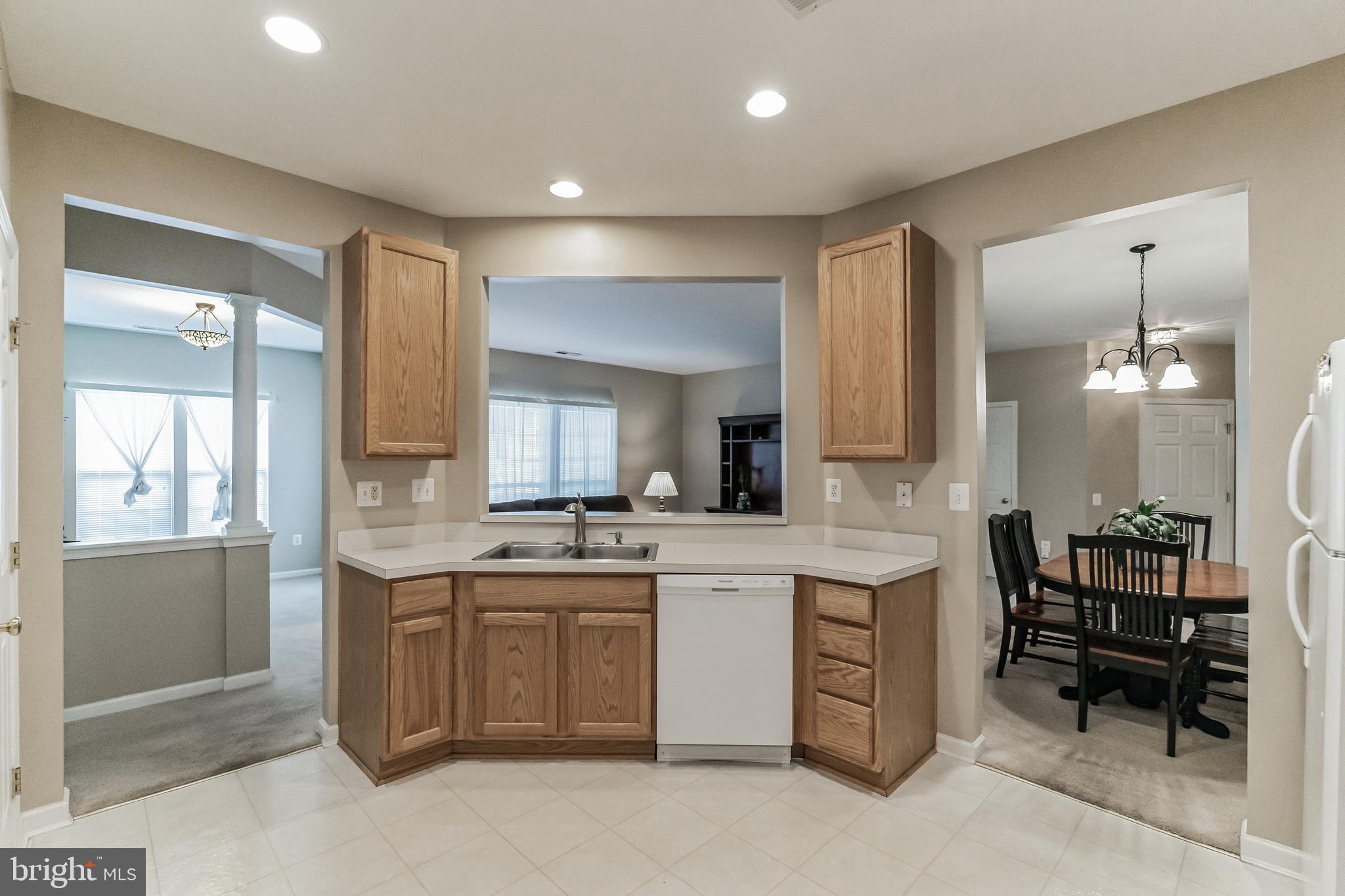 200 Beech Boulevard, Unit 104 Warrington, PA 18976 - Photo 13 of 30 a kitchen with cabinets and chairs