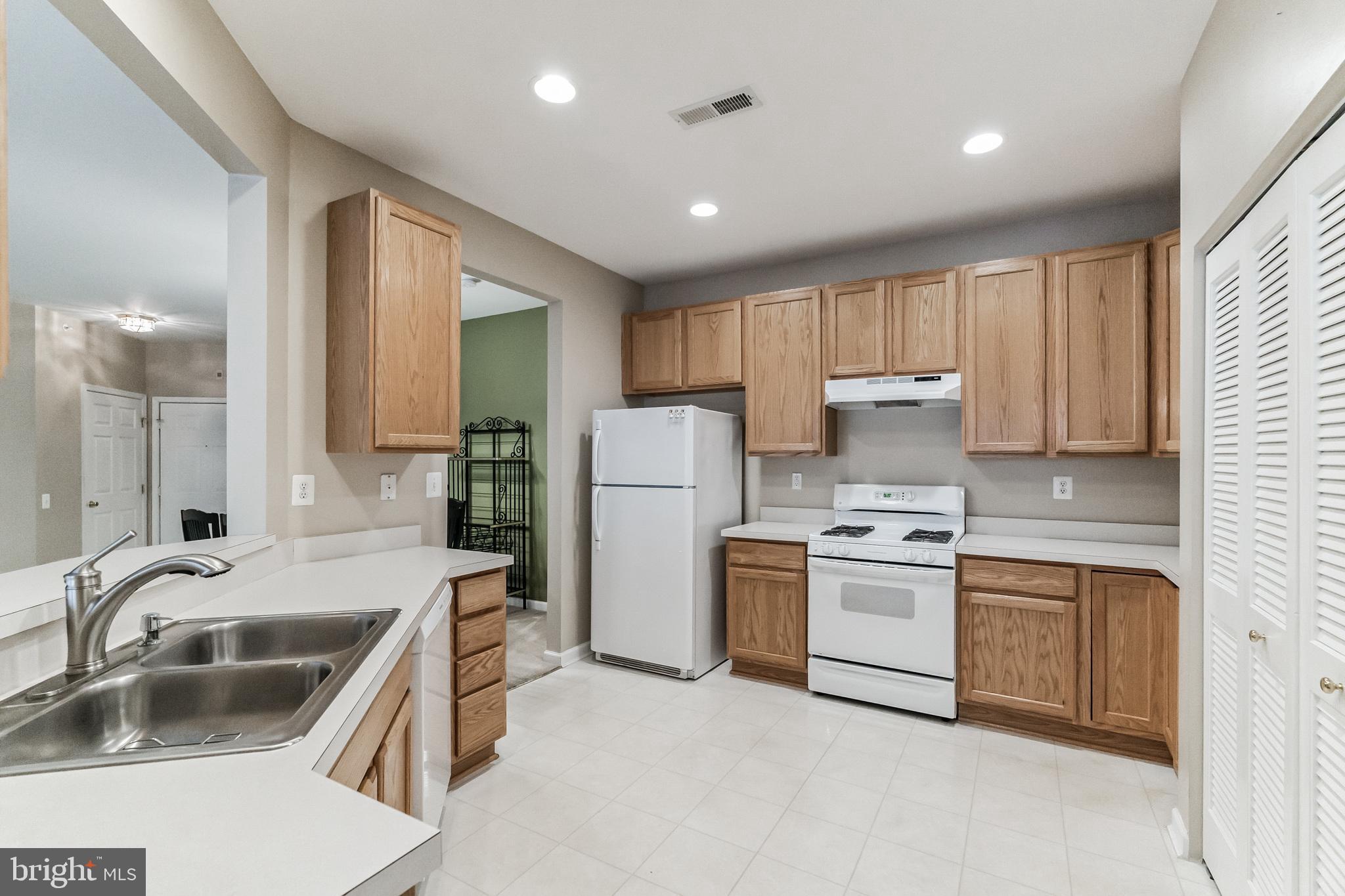 200 Beech Boulevard, Unit 104 Warrington, PA 18976 - Photo 14 of 30 a kitchen with a sink stove and refrigerator
