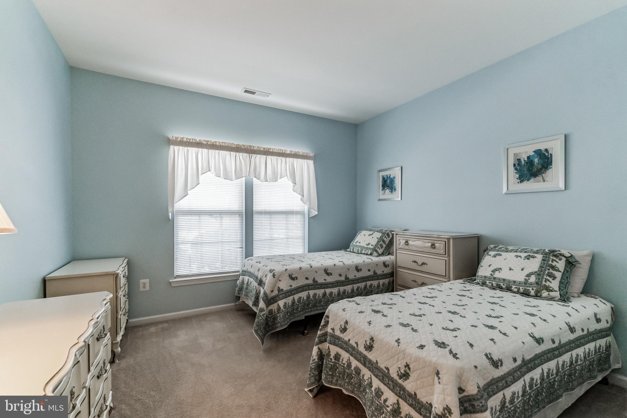 200 Beech Boulevard, Unit 104 Warrington, PA 18976 - Photo 21 of 30 a bedroom with two beds and a window