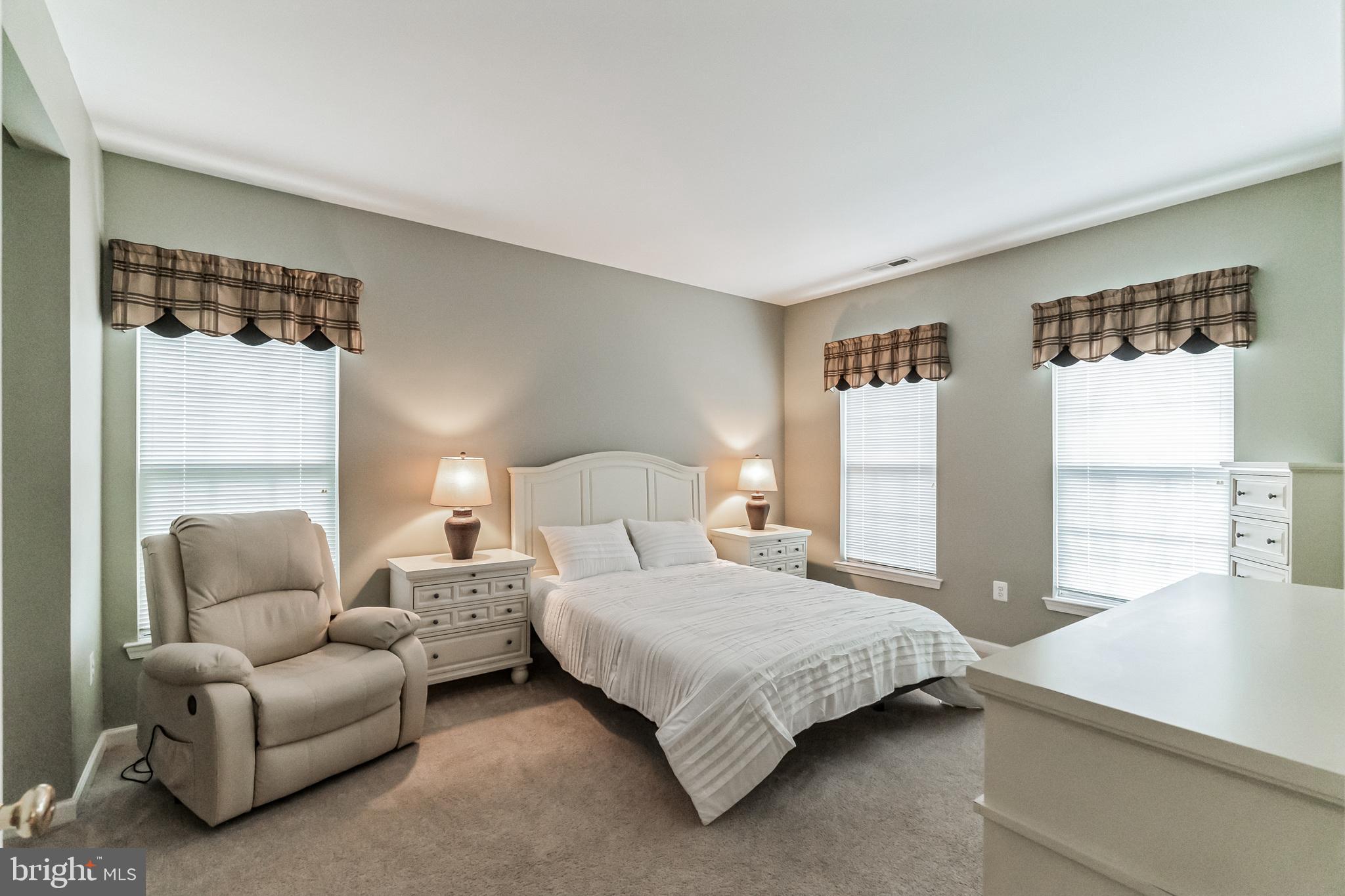 200 Beech Boulevard, Unit 104 Warrington, PA 18976 - Photo 24 of 30 a bedroom with bed couch and window