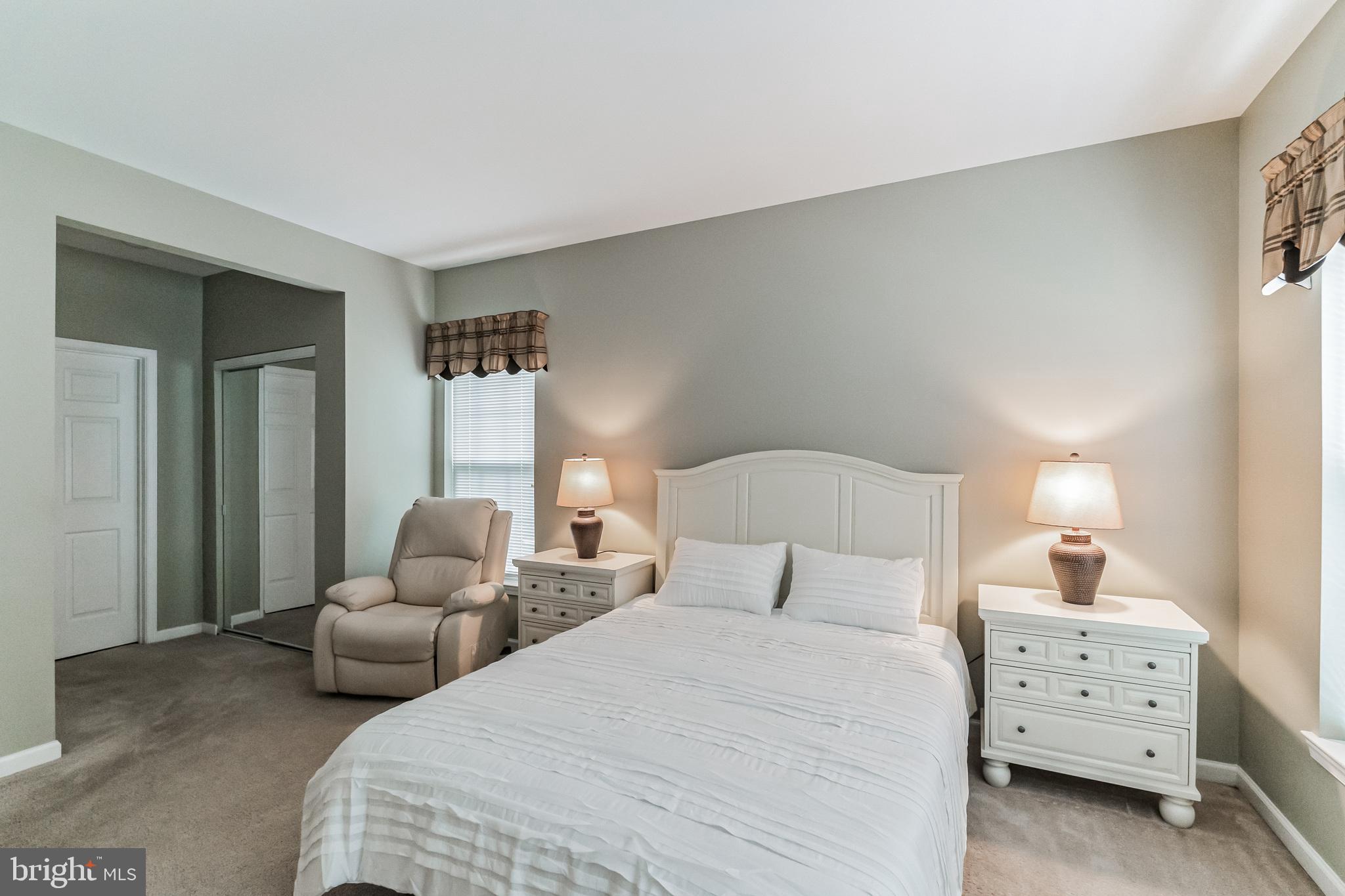 200 Beech Boulevard, Unit 104 Warrington, PA 18976 - Photo 25 of 30 a bedroom with two bed and a lamp