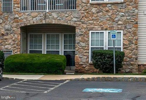 200 Beech Boulevard, Unit 104 Warrington, PA 18976 - Photo 3 of 30 front view of a house with a garden