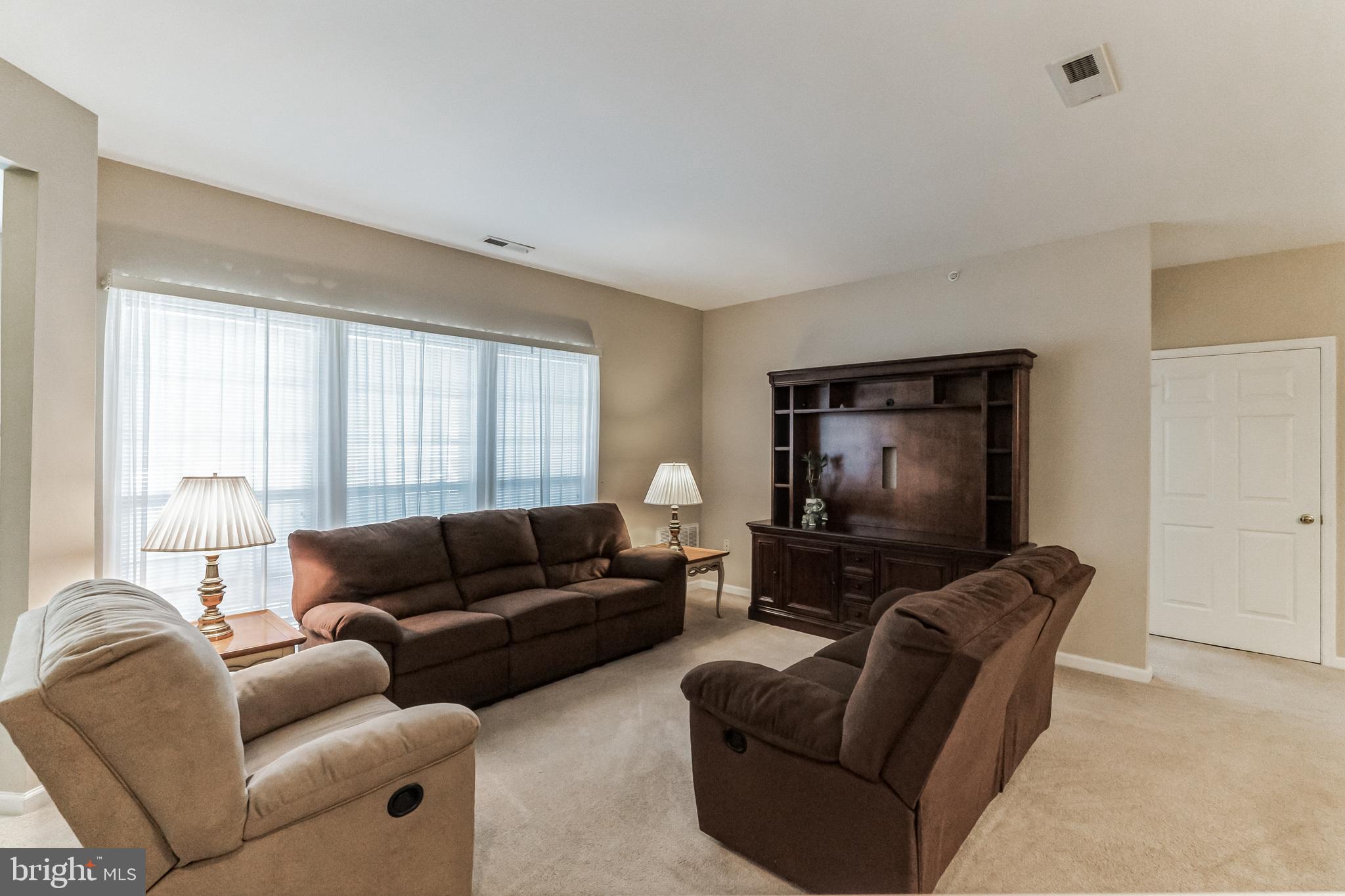 200 Beech Boulevard, Unit 104 Warrington, PA 18976 - Photo 6 of 30 a living room with furniture and a flat screen tv