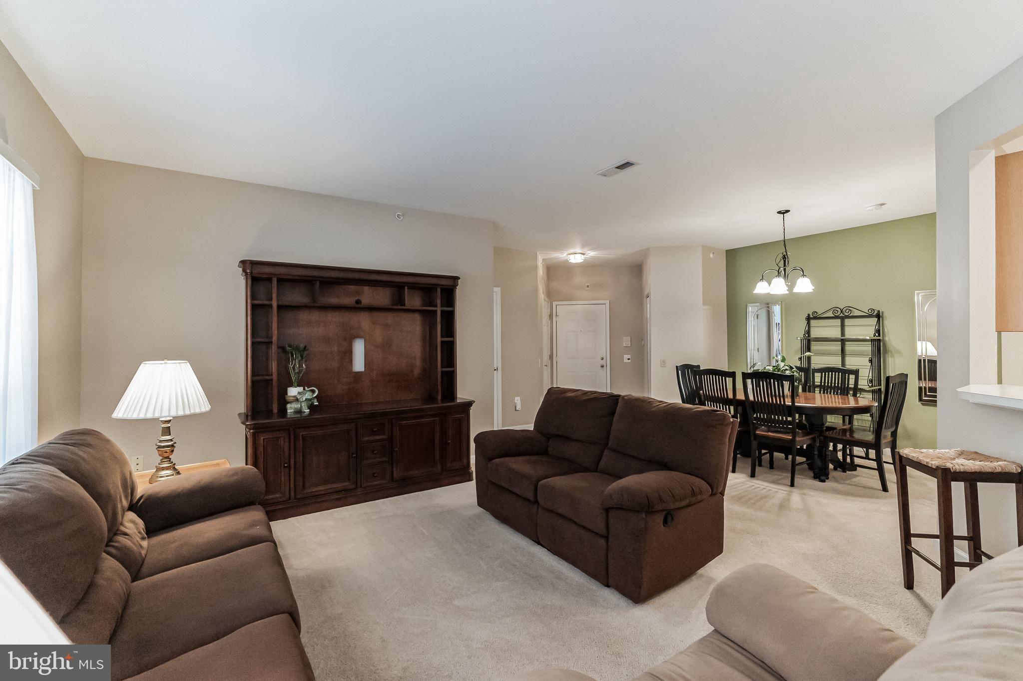 200 Beech Boulevard, Unit 104 Warrington, PA 18976 - Photo 7 of 30 a living room with furniture and a flat screen tv