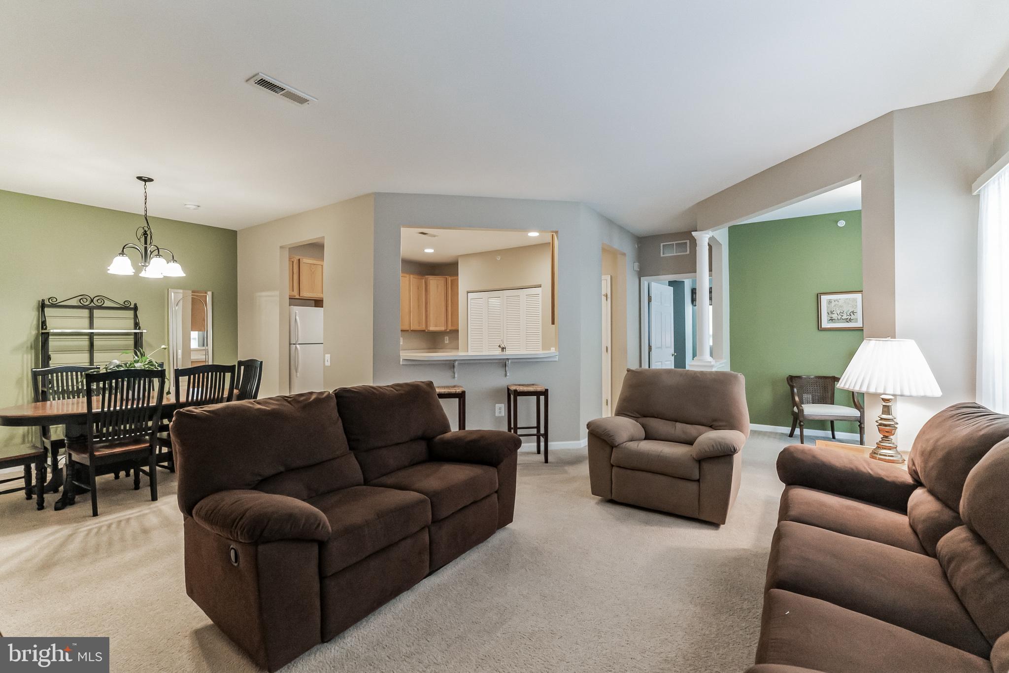 200 Beech Boulevard, Unit 104 Warrington, PA 18976 - Photo 8 of 30 a living room with furniture a lamp and a chandelier