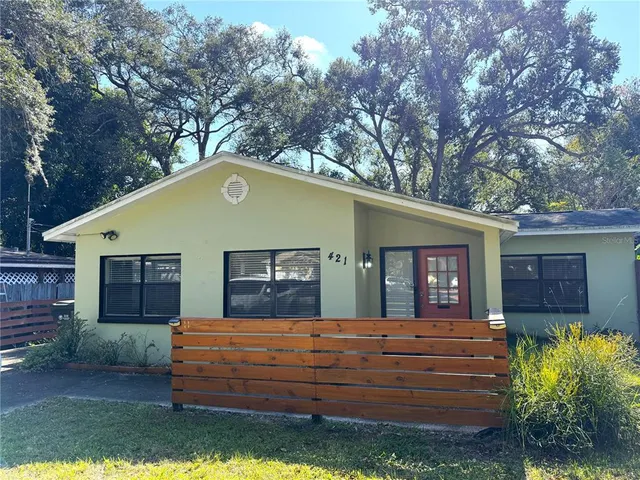 a front view of house with a garden