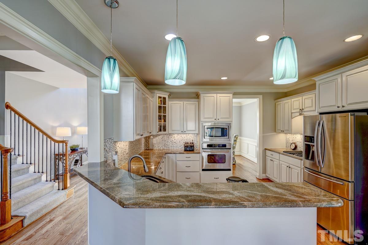 2724 Peachleaf Street Raleigh, NC 27614 - Photo 13 of 45 a kitchen with stainless steel appliances granite countertop a sink refrigerator and cabinets