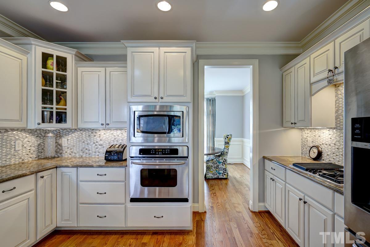 2724 Peachleaf Street Raleigh, NC 27614 - Photo 17 of 45 a kitchen with stainless steel appliances a stove sink and cabinets