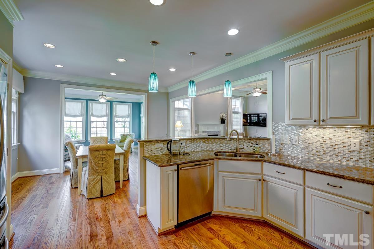 2724 Peachleaf Street Raleigh, NC 27614 - Photo 18 of 45 a kitchen with a sink and wooden floor