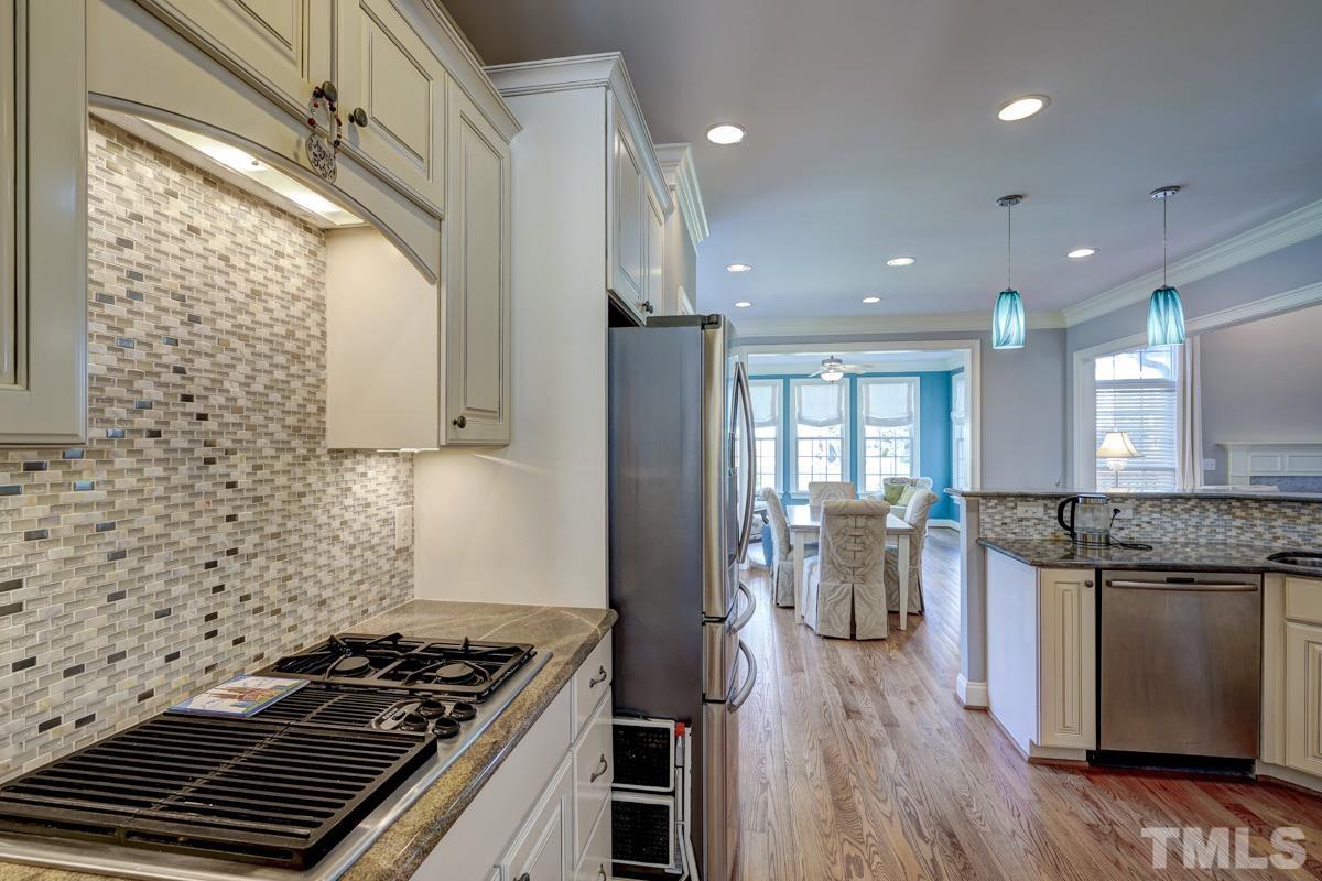 2724 Peachleaf Street Raleigh, NC 27614 - Photo 19 of 45 a kitchen with refrigerator and stove