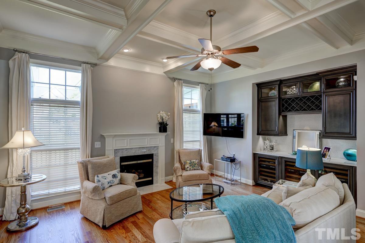 2724 Peachleaf Street Raleigh, NC 27614 - Photo 24 of 45 a living room with furniture a fireplace and a flat screen tv