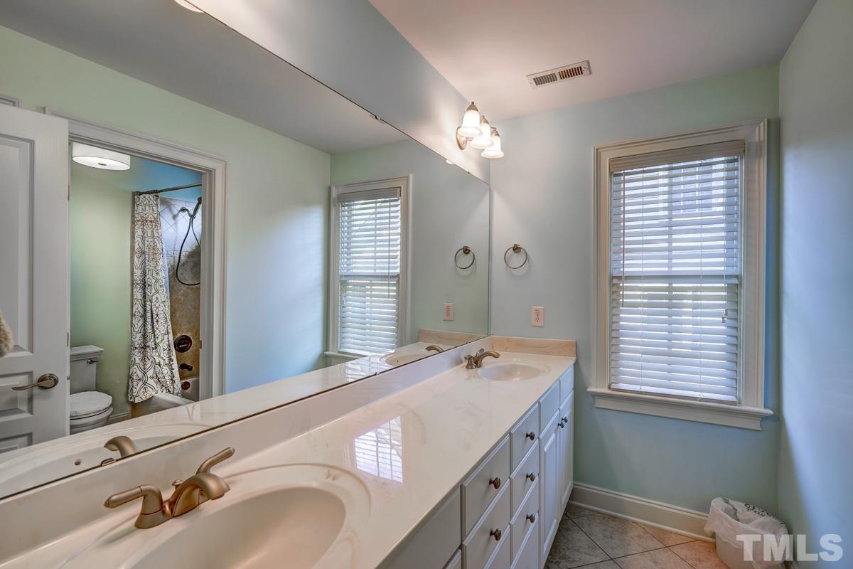 2724 Peachleaf Street Raleigh, NC 27614 - Photo 36 of 45 a bathroom with a double vanity sink and a mirror