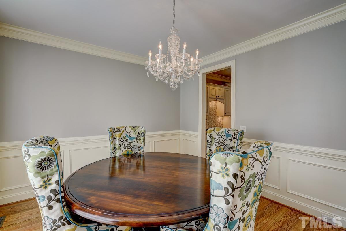 2724 Peachleaf Street Raleigh, NC 27614 - Photo 5 of 45 a dining room with furniture a chandelier and wooden floor