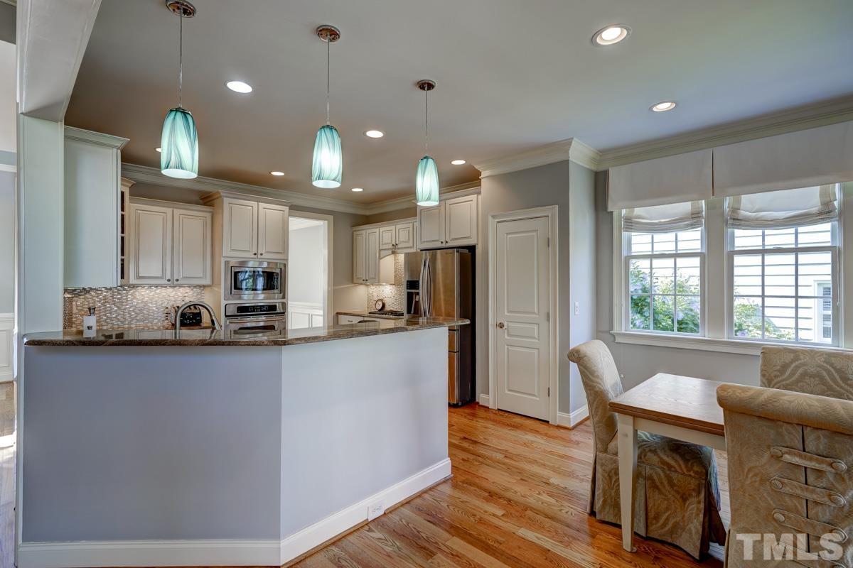 2724 Peachleaf Street Raleigh, NC 27614 - Photo 6 of 45 a kitchen with stainless steel appliances granite countertop sink microwave and wooden floor