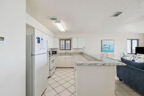 a bathroom with a granite countertop sink and a large mirror