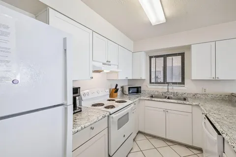 a view of a hallway with wooden cabinets