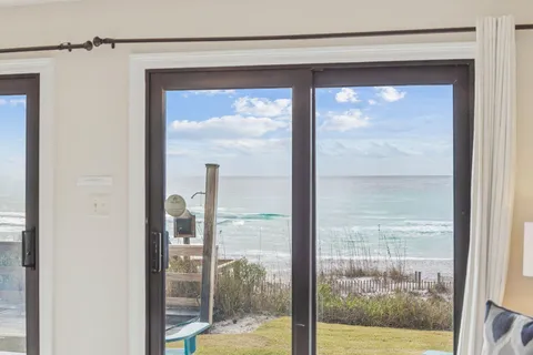 a view of a dining room with furniture a chandelier and wooden floor