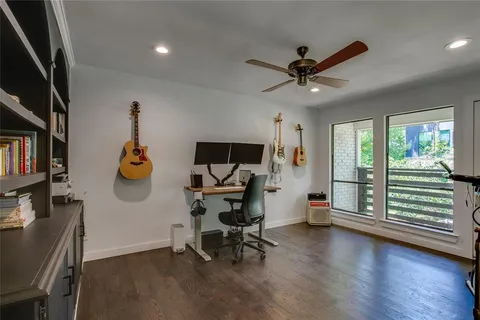 a view of a workspace with furniture and a window